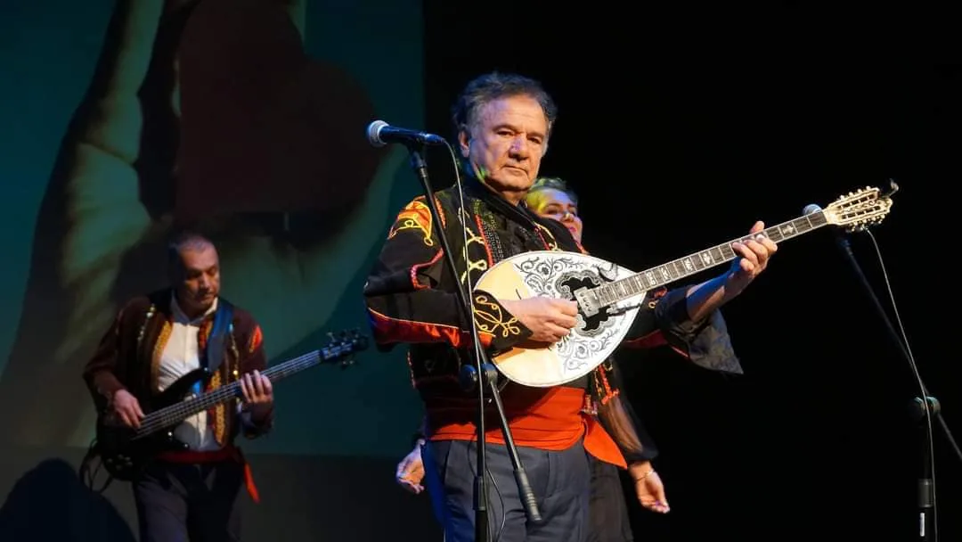 Mythos bouzouki player performing on stage