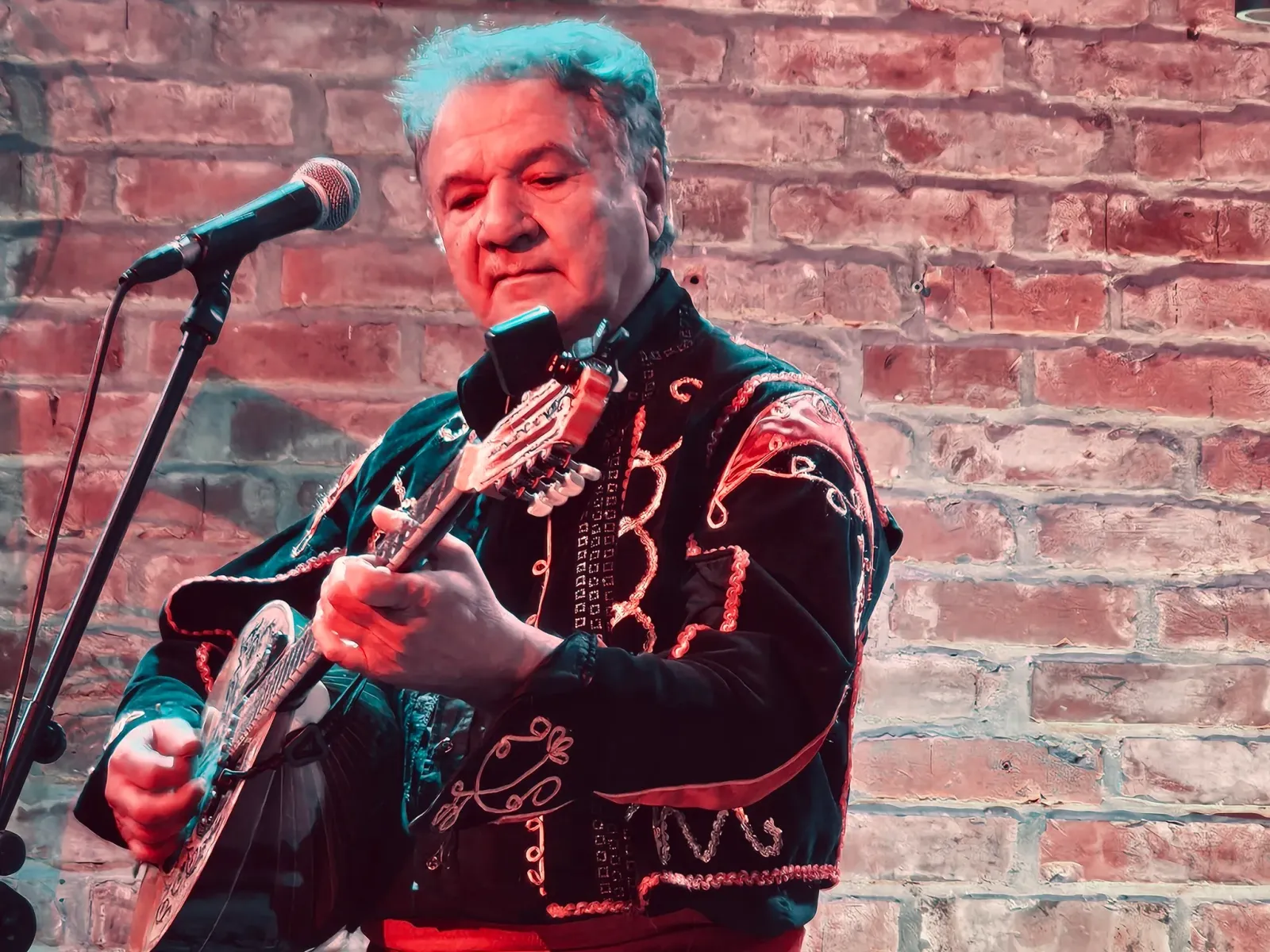 Mythos bouzouki player performing live in Greek costume