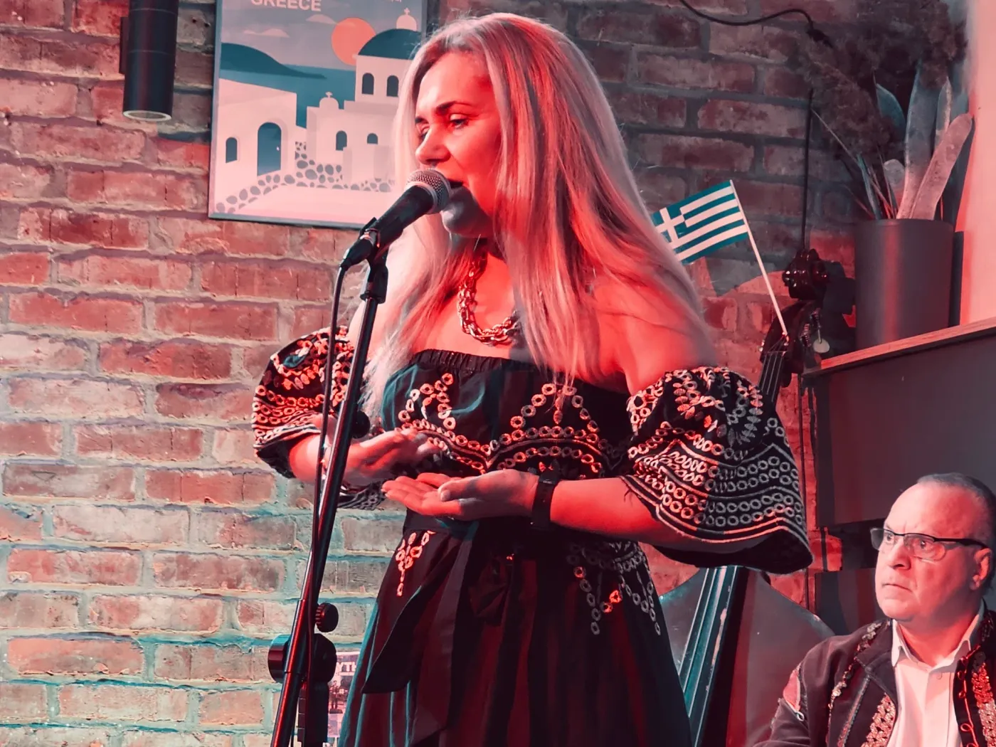 Mythos vocalist performing at a Greek evening event